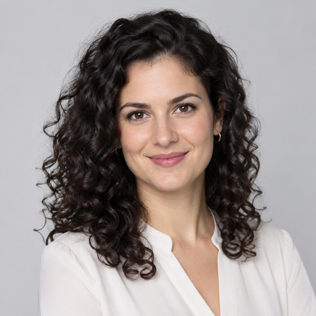 Studio portrait of a professional woman with dark curly hair